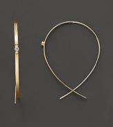 A single diamond gleams from the center of these wire-through 14K gold earrings.
