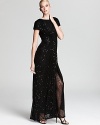 Tadashi Shoji's glamorous, sequin encrusted gown gets seductive with a high front slit in sheer mesh.