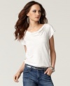 The simple tee gets revamped with metallic stripes and a cute draped neckline in this look from Calvin Klein Jeans!