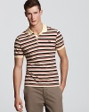 With a vibrant punch of multicolored stripes, this classic polo from Lacoste gets a stylish-yet-edgy update.