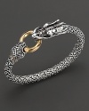 From the Naga collection, a woven sterling chain bracelet with dragon head and 18 Kt. gold ring, designed by John Hardy.