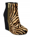 Two-for-one glam. Zebra-print cow hair and black suede are joined together by one awesome exposed zipper on the upper of RACHEL Rachel Roy's Camino wedge booties.