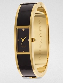 A chic enamel accented goldtone bangle timepiece. Quartz movementWater resistant to 3 ATMRectangular goldtone case, 16mm (0.6)Smooth bezelBlack dialDot hour markersSecond hand Enamel accented goldtone bangleImported