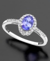 Color your look with happiness. This beautiful ring features oval-cut tanzanite (1/2 ct. t.w.) and round-cut diamond (1/10 ct. t.w) set in 14k white gold.