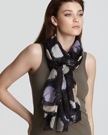 A lightweight silk scarf featuring a messy and playful polka dot print.