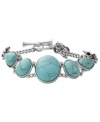 Breezy, bohemian style. Perfect for the free spirit, Fossil's trendy toggle bracelet includes reconstituted turquoise stones set in vintage silver tone mixed metal bezels with orchid details. Approximate length: 8 inches.