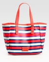 An easy carryall crafted from painted canvas, featuring a signature plaque in a vibrant tone. Double top handles, 7¼ dropMagnetic top closureOne inside zip pocketOne inside open pocket13¼W X 11½H X 5¾DImported