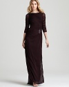 Adrianna Papell perfects understated glamour with this long sleeved gown--a crystal brooch lends a hint of sparkle.