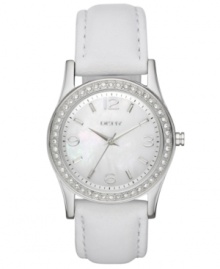 Refined and tranquil, this timepiece from DKNY soothes the mind with each passing second. Crafted of white leather strap and round stainless steel case. Bezel embellished with 48 clear crystal accents. White mother-of-pearl dial features silver tone numerals at three, six, nine and twelve o'clock, stick indices, minute track, silver tone three hands and logo at twelve o'clock. Quartz movement. Water resistant to 50 meters. Two-year limited warranty. Refined and tranquil, this timepiece from DKNY soothes the mind with each passing second. Crafted of white leather strap and round stainless steel case. Bezel embellished with 48 clear crystal accents. White mother-of-pearl dial features silver tone numerals at three, six, nine and twelve o'clock, stick indices, minute track, silver tone three hands and logo at twelve o'clock. Quartz movement. Water resistant to 50 meters. Two-year limited warranty.