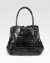 Stunning crocodile skin, superior tailoring and unique shape make for a finished, luxurious look.Double top handles, 7 dropMagnetic and zip closureOne outside zip pocketTwo inner compartmentsOne center zip compartmentOne inside zipper pocketThree inside open pocketsSuede lining>12W X 10H X 5DImported