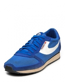 Diesel takes on the classic running shoe, adding tonal suede panels and a bold contrast swoop to the lightweight nylon upper. Diesel takes on the classic running shoe, adding tonal suede panels and a bold contrast swoop to the lightweight nylon upper.