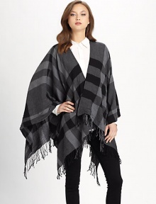 A check design with a fringe trim. Open front Extra fine wool About 26 from should to hem Dry clean Imported A check design with a fringe trim. Open front Extra fine wool About 26 from should to hem Dry clean Imported