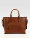Roomy carryall crafted from luxurious leather with dual straps for carrying versatility.Double top handles, 5½ dropAdjustable, removable shoulder strap, 13-16½ dropMagnetic snap closureProtective metal feetOne inside zip pocketTwo inside open pocketsCanvas lining14W X 10½H X 5½DMade in Italy