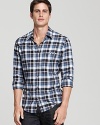 Brightly blue and black, this BOSS Orange plaid shirt updates the classic style with a slim fit for year-round style.