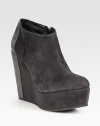 Suede ankle boot in a modern, two-tone design with a self-covered wedge and an exposed side zipper. Self-covered wedge, 5 (125mm)Covered platform, 1½ (40mm)Compares to a 3½ heel (90mm)Suede upperSide zipperLeather liningRubber solePadded insoleMade in ItalyOUR FIT MODEL RECOMMENDS ordering one size up as this style runs small. 