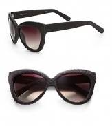 An ultra-textural design in a retro style. Available in aubergine with brown lens. Snakeskin covered temples100% UV protectionImported 