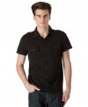 Black out. This short-sleeved polo-styled shirt from Calvin Klein Jeans is a casual staple.