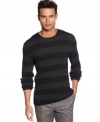 Bold horizontal stripe sweater by Calvin Klein with silhouettes of multi-circles on each stripe makes it a style standout.