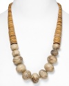 Tribal-inspired chic from RJ Graziano. This bold necklace marries graduated tan stone discs with multifaceted bone beads for a versatile piece that works with a coral dress or white jeans.