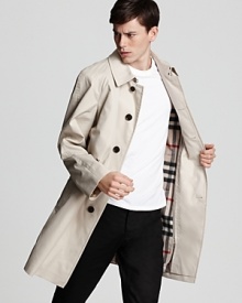 Covered placket long trench coat with zip out warmer. Check under stand collar. Side buttoned pockets. Button tab at cuffs. Covered placket long trench coat with zip out warmer. Check under stand collar. Side buttoned pockets. Button tab at cuffs.