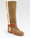 Shearling trim adds textural appeal to this suede design, finished with a wrap-around leather ankle strap. Rubber heel, 1¼ (30mm)Rubber platform, ½ (15mm)Compares to a ¾ heel (20mm)Shaft, 15Leg circumference, 16Suede upper with shearling trim and a leather adjustable tab ankle strapPull-on styleLeather liningRubber solePadded insoleImported