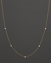 A yellow gold chain with five bezel-set diamond stations.