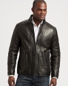 Make a statement without saying a word in this exquisite leather jacket treated perfectly to exude a look that is both rugged and refined.Zip frontStand collarSide slash pocketsAbout 28 from shoulder to hemLeatherDry cleanImported