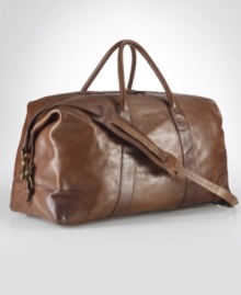 An ideal size for travel, this heritage duffle is rendered in durable cotton twill with glossy leather accents and a removable webbed shoulder strap for versatile on-the-go styling. An ideal size for travel, this heritage duffle is rendered in durable cotton twill with glossy leather accents and a removable webbed shoulder strap for versatile on-the-go styling.