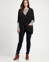 A boxy fit and a touch of stretch give this button-down cardigan universal appeal. You will love how this jersey knit pairs with skinny jeans or a sleek pencil skirt.V-neckElbow-length sleevesButton frontPatch pocketsDipped hemAbout 25 from shoulder to hem94% viscose/4% nylon/2% spandexDry cleanImported of Italian fabric