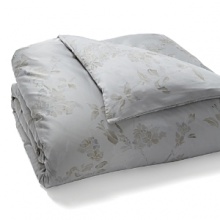 A soft floral in muted blue and taupe is scattered across a silvery grey background in this collection from Calvin Klein Home. A soft floral in muted blue and taupe is scattered across a silvery grey background in this collection from Calvin Klein Home.