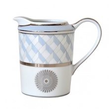 Carefully rendered in a style reminiscent of neoclassic trompe l'oeil-a French term for artwork that depicts optical illusions-a captivating geometric rosette motif traverses this elegant porcelain creamer from Bernardaud. Delicate shades of ice blue, mother-of-pearl and gray are enhanced by a fine platinum trim and medallion design. Carefully rendered in a style reminiscent of neoclassic trompe l'oeil-a French term for artwork that depicts optical illusions-a captivating geometric rosette motif traverses this elegant porcelain creamer from Bernardaud. Delicate shades of ice blue, mother-of-pearl and gray are enhanced by a fine platinum trim and medallion design.