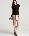 Smart and structured, this BCBGMAXAZRIA dress lends a luxe look with a color block design, puffed sleeves and a flared hem.