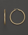 Always chic, these classic 18K yellow gold hoops are the perfect finish to any--and every--look.