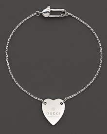 From the Trademark Collection, this sweet sterling silver bracelet features a woven chain with engraved logo heart charm. Designed by Gucci.