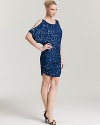 Split dolman sleeves add edge to this Aidan Mattox sequin dress, which needs nothing more than a pair of soaring metallic platforms.