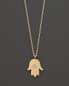 A diamond adds sparkle to a 14K. yellow gold hamsa necklace by Meira T.