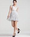 A modern take on '20s glamour, this Basix dress boasts an opulently beaded bodice atop a tiered fringe skirt.