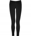 A closet must-have, these super skinny pants in black stretch nylon are a signature design from J Brand Jeans - Classic five-pocket style, mid-rise waist, zip fly front, belt loops, flattering back pockets - Narrow leg and figure-flattering slim cut - Wear with a chunky-knit oversized sweater and favorite ankle booties