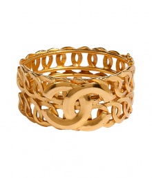 Ultra-luxe golden 1996 double C row bangle - This statement-making bracelet is authentic vintage Chanel from 1996 - Stylish gold-plated bracelet with two rows of interlocking circles and the iconic double C Chanel logo affixed on front - Amp up any outfit with this ultra-chic accessory - Perfect for cocktail attire or to dress up daywear Ultra-luxe golden 1996 double C row bangle - This statement-making bracelet is authentic vintage Chanel from 1996 - Stylish gold-plated bracelet with two rows of interlocking circles and the iconic double C Chanel logo affixed on front - Amp up any outfit with this ultra-chic accessory - Perfect for cocktail attire or to dress up daywear