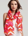 A lightweight chevron printed scarf with self fringe edges and a flashy color palette.