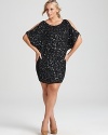 Split sleeves offer a demure peek of skin on this Aidan Mattox sequin dress.