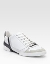 Sleek and sporty sneakers constructed in leather with patent and suede trim. Padded insole Rubber sole Made in Italy 