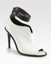 An ankle strap puts a modern spin on this sculpted two-tone leather design, with a sexy open toe and towering heel. Stacked heel, 4¾ (120mm)Leather upperOpen toeBack zipLeather lining and solePadded insoleMade in Italy