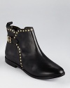 These little black booties from Pour La Victoire lend a feminine look with edge--golden studs accent a short silhouette.