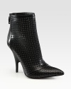 Allover perforations and an exposed back zipper amp up this ankle-grazing leather design. Self-covered heel, 2 (50mm)Leather upperExposed back zipperLeather lining and solePadded insoleImported