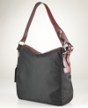 A laid-back silhouette gets an elegant upgrade with this haute hobo from Lauren Ralph Lauren. Sleek, durable nylon with equestrian-inspired stirrup hardware exudes functional style, while the rich leather accents add instant polish and sophistication.