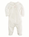 A beautiful long-sleeved footed coverall in plush velour is highlighted with pretty puff sleeves and embroidery.