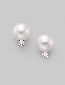 From the Akoya Collection. Classic white cultured pearl studs with sparkling diamond accents, set in 18k gold. 7mm white round cultured pearls Quality: A+ Diamonds, 0.10 tcw 18k white gold Post back Imported