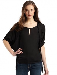 THE LOOKRound necklineFront keyhole with button closure Cascading fringe necklineShort dolman sleeves with gathered button cuffsTHE FITAbout 23 from shoulder to hemTHE MATERIALRayonCARE & ORIGINDry cleanImportedModel shown is 5'9 (175cm) wearing US size Small. 