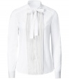 Elegant white blouse of fine cotton - Tuxedo styling with pleated front and tied, fitted collar - Long, slim sleeves with buttoned cuffs - Style classically with pencil skirt, suit pants and heels or mix it up with a thin leather jacket and skinny jeans